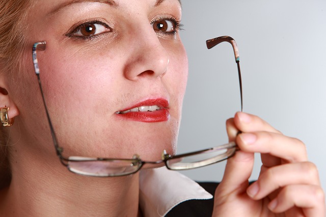 Woman holding her eyeglasses